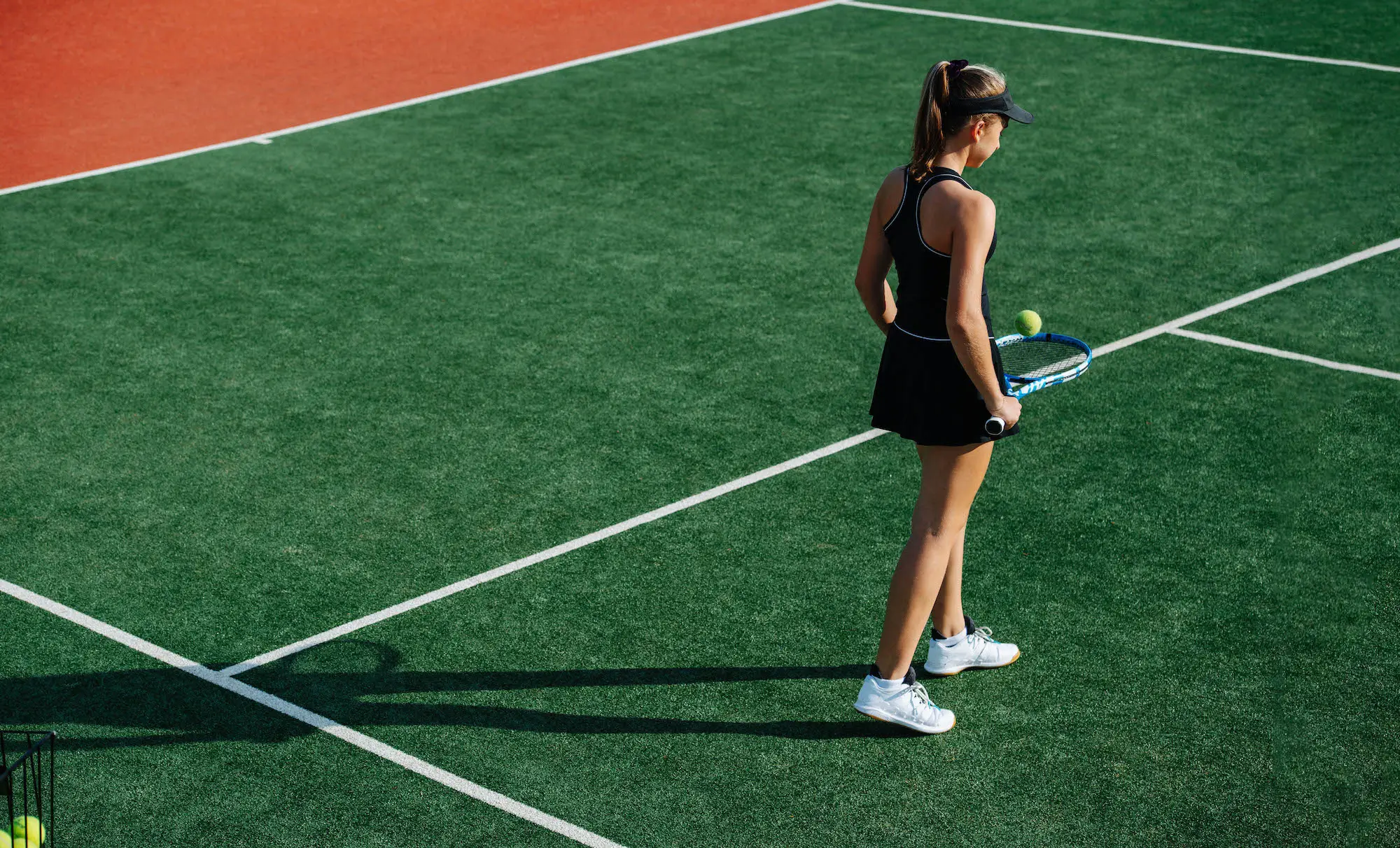 tennis player standing on artificial grass court