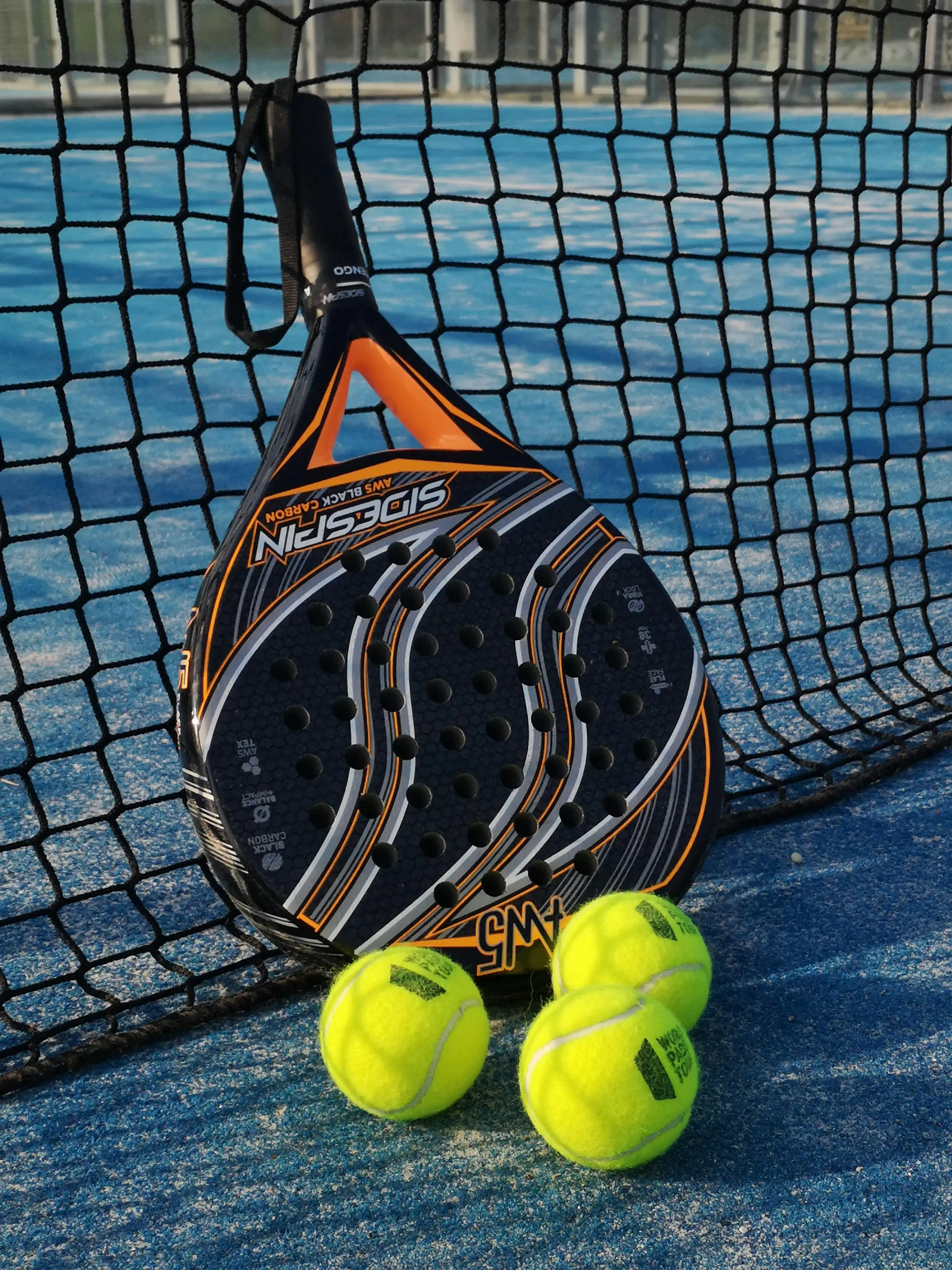 close up of padel racket on artificial padel court